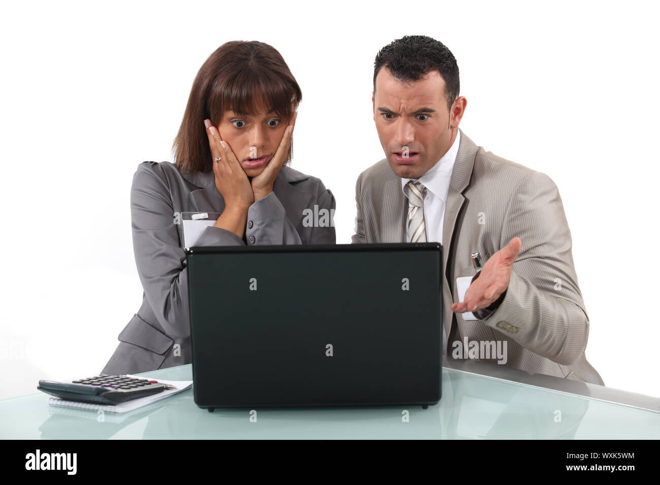 A couple of businesspeople getting bad news. Stock Photo