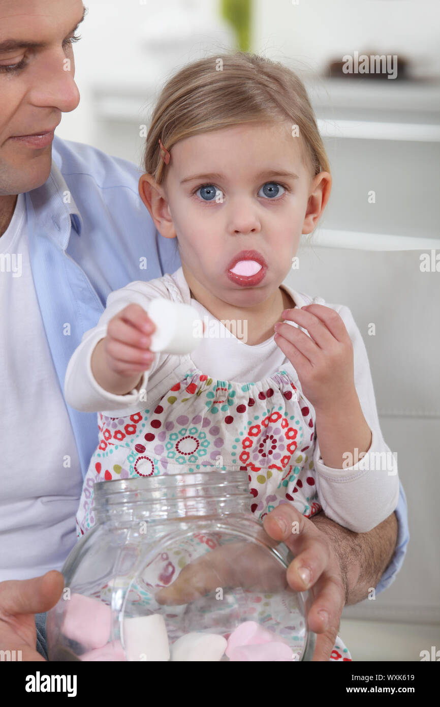 Little girl eating candy Stock Photo Alamy