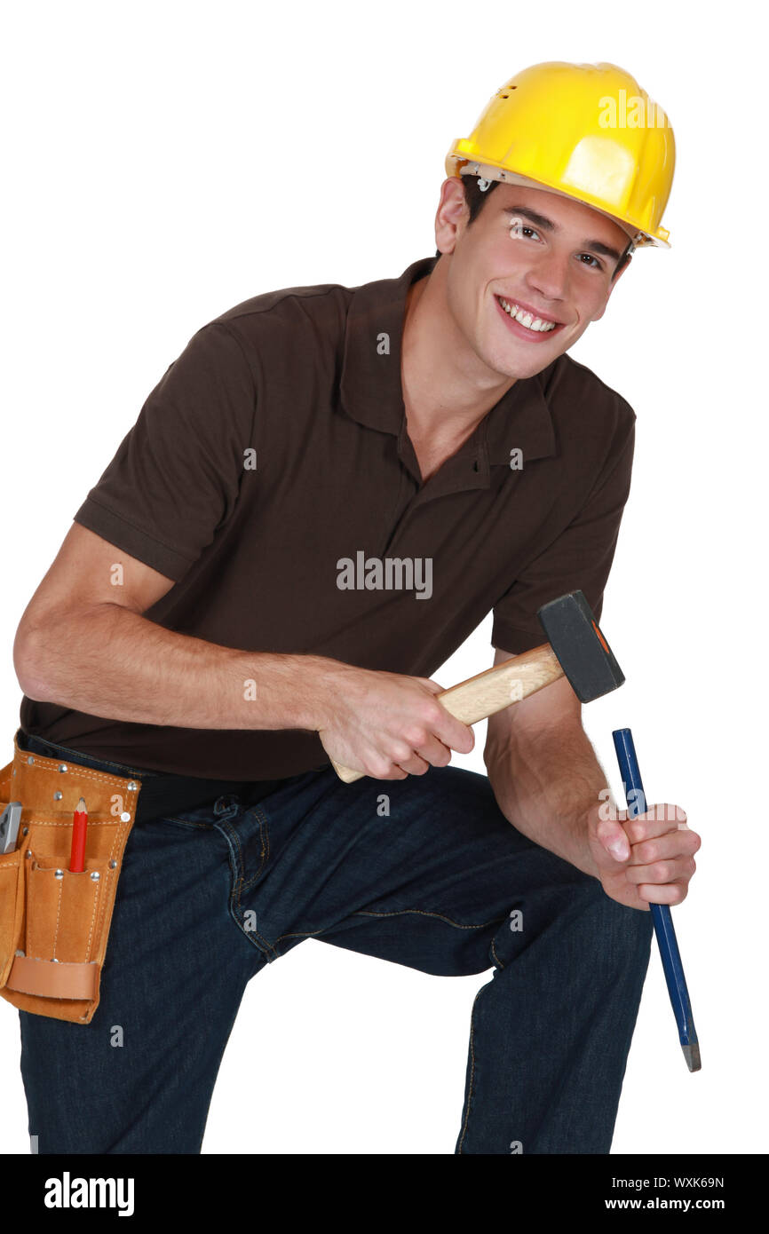 Man hitting chisel with hammer Stock Photo