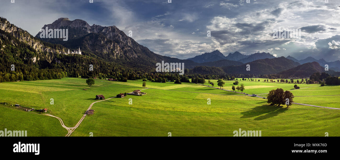 Rural landscape with Neuschwanstein and Hohenschwangau castles in distance, Schwangau, Bavaria, Germany Stock Photo