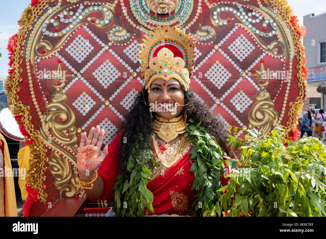 A beautiful Hindu woman with long curly hait dressed as the Goddess Mariamma the Madrassi Parade for unity in the community in Richmond Hill, Queens. Stock Photo