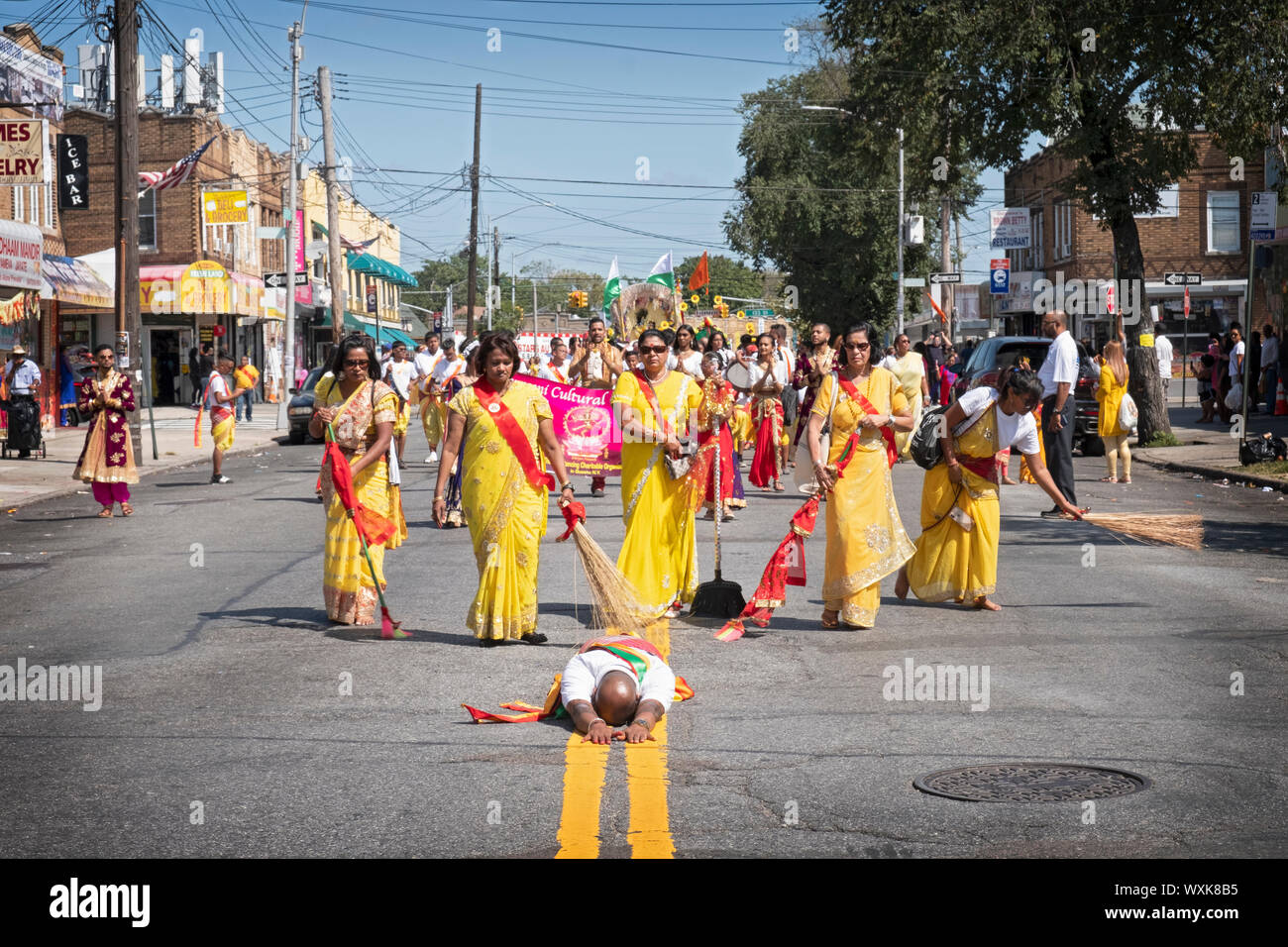 A devout Hindu worshipper lies prostrate in fervent prayer at the Madrassi Parade for unity in the community. In Richmond Hill, Queens. Stock Photo
