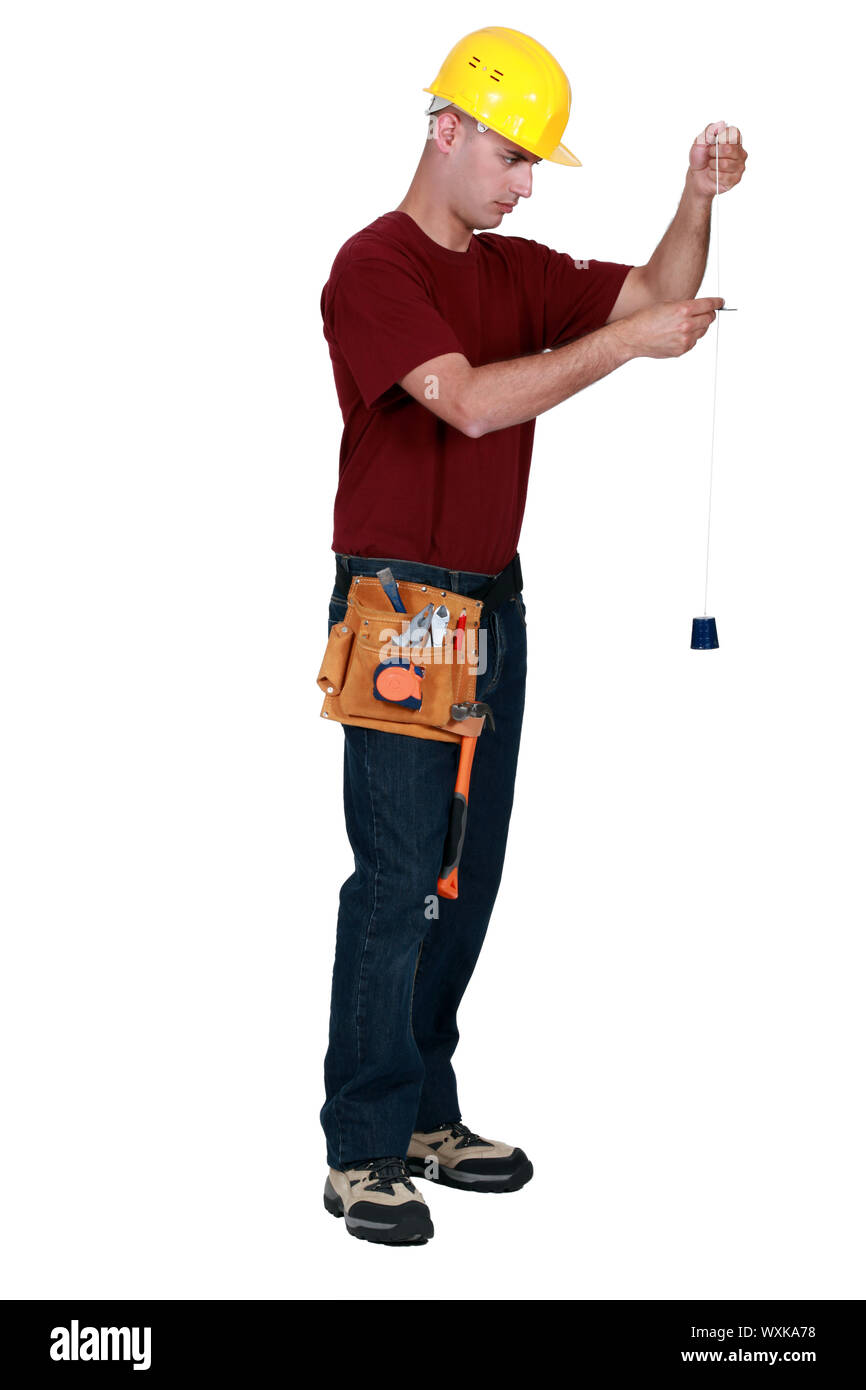 Builder with a plumb line Stock Photo Alamy