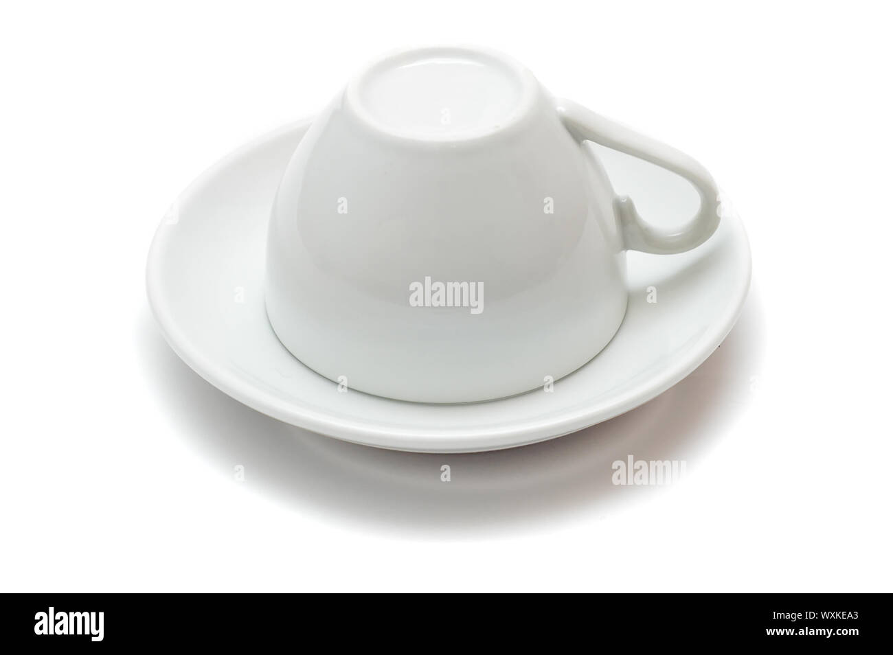 upside-down cup over saucer isolated on white background Stock Photo ...