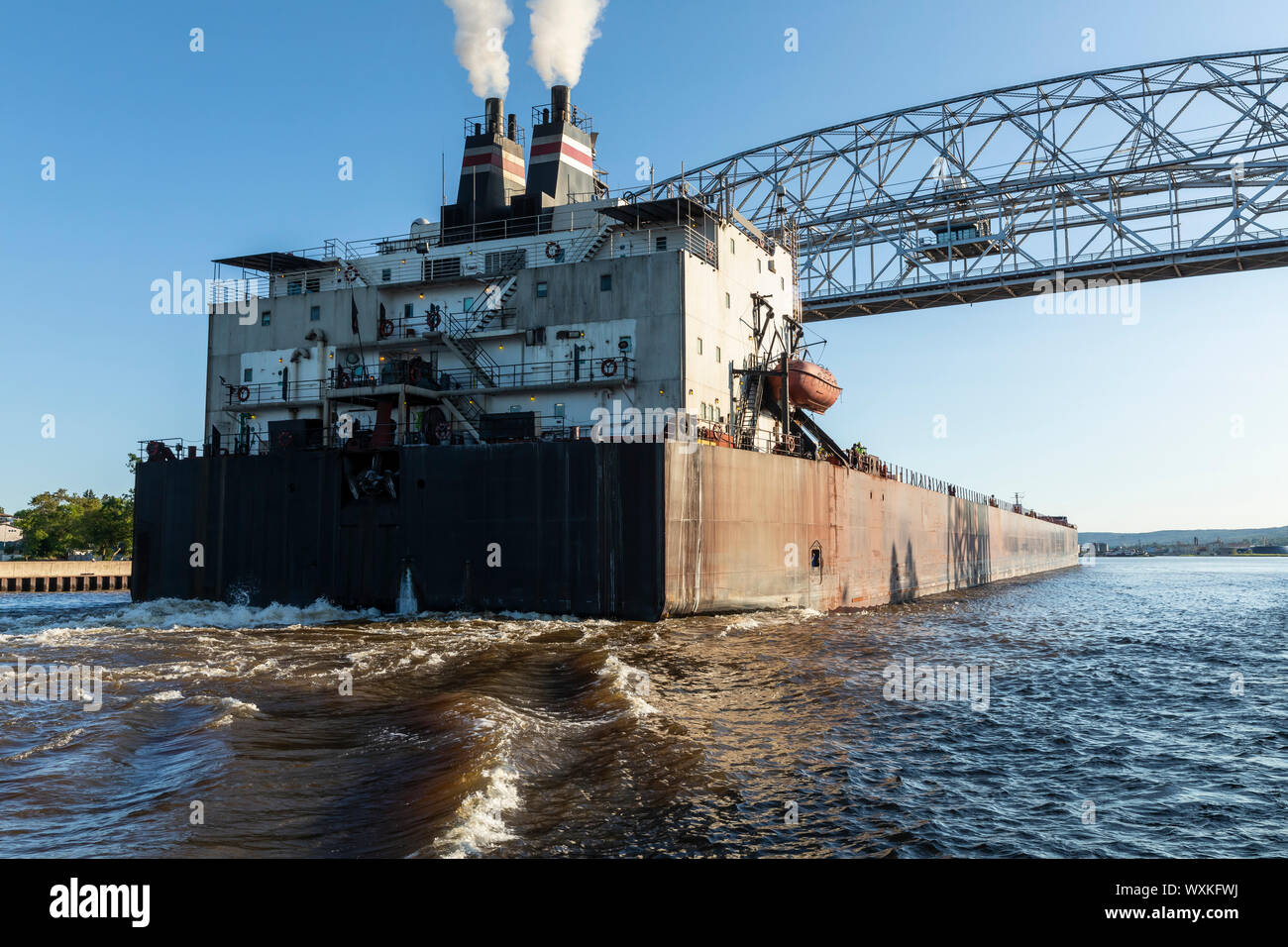 A Ship Passing Under A Lift Bridge On Lake Superior Stock Photo