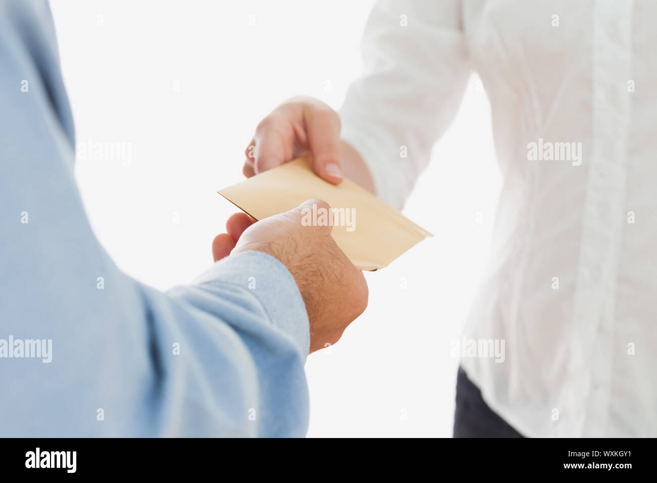 Man handing envelope to woman hi-res stock photography and images - Alamy