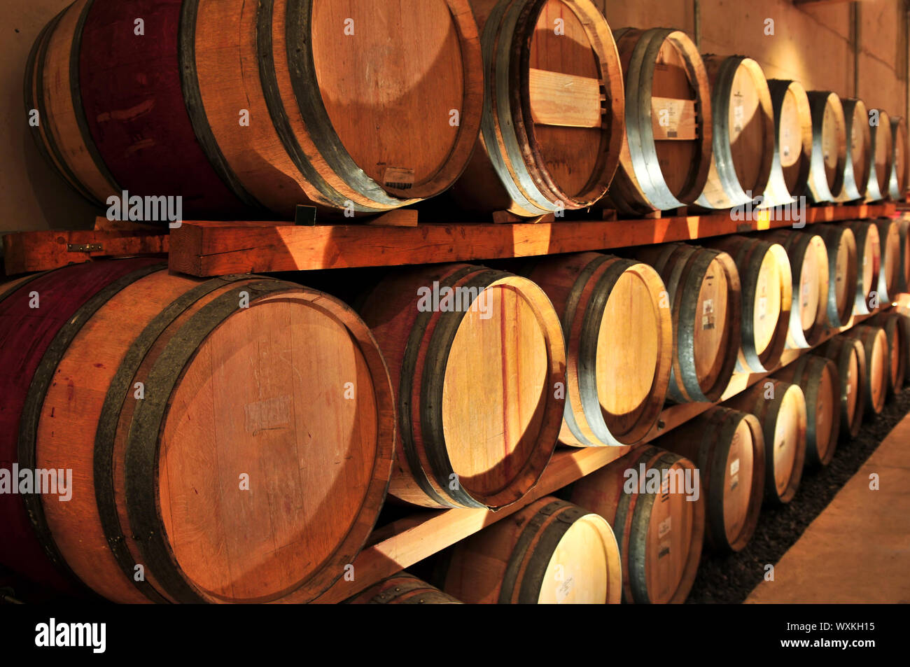 Stacked oak wine barrels in winery cellar Stock Photo - Alamy