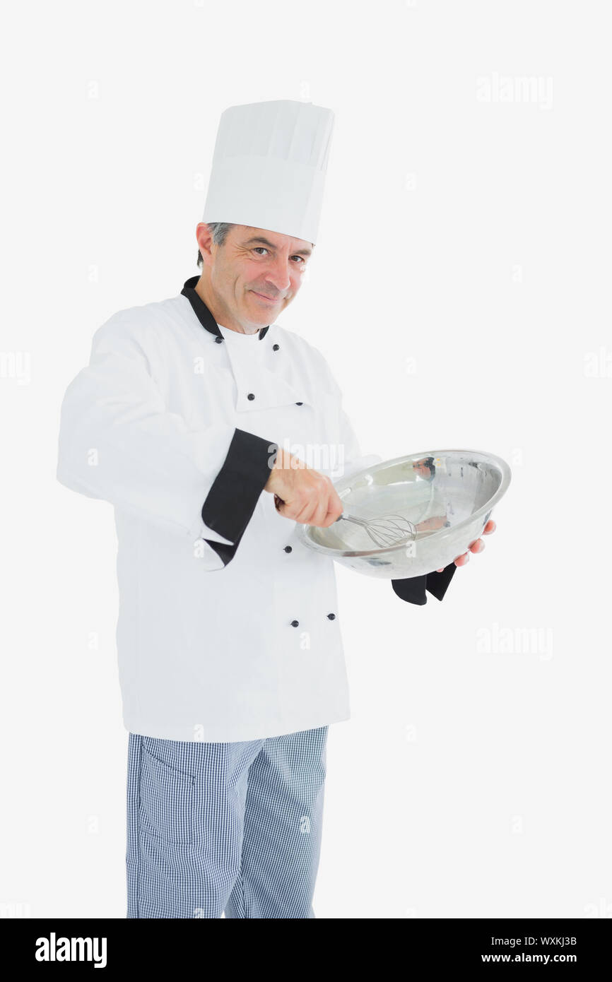 Portrait of male chef using whisk and mixing bowl over white background ...