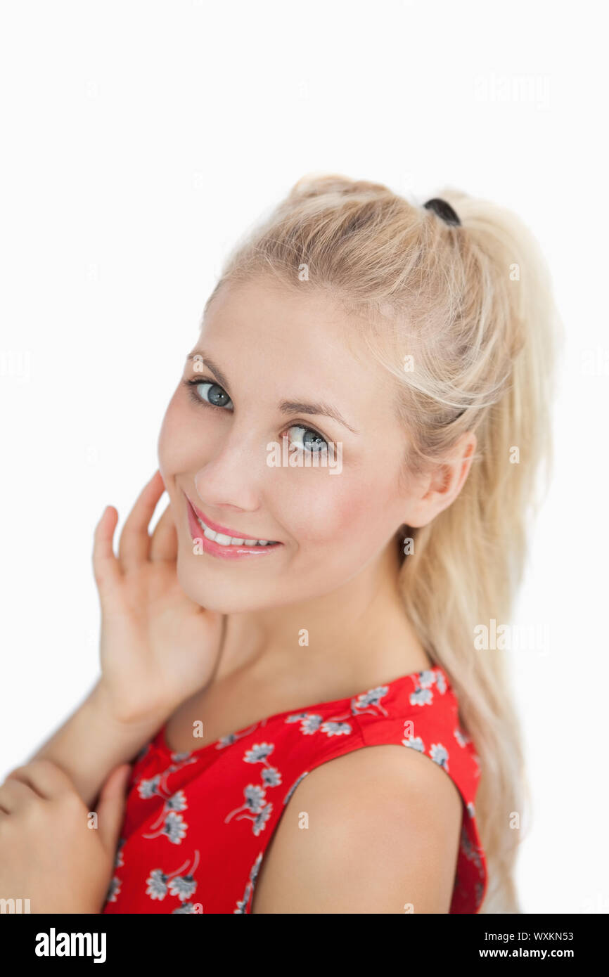 Closeup portrait of a cute young woman smiling over white background ...
