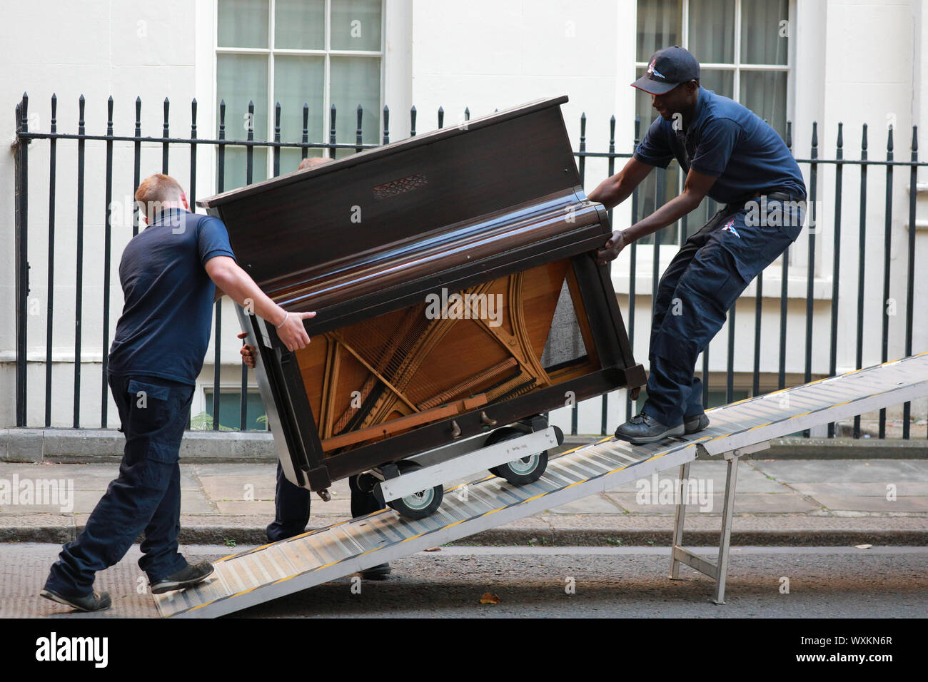 Westminster, London, UK. 17th Sep, 2019. Two delivery men struggle with the  large musical instrument. A piano is delivered to No 11, Downing Street by  a removal firm. The flat above No