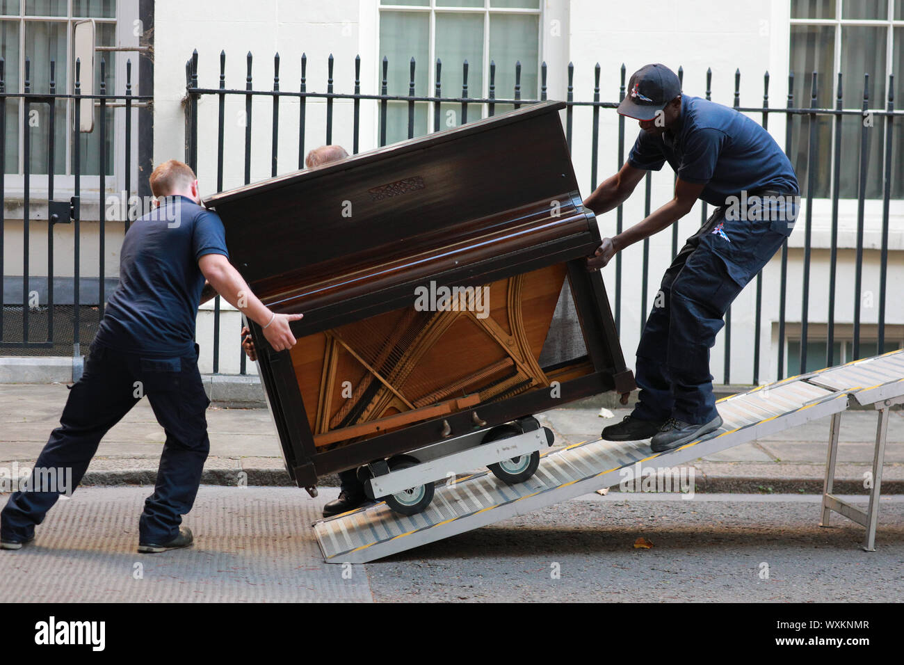 Westminster, London, UK. 17th Sep, 2019. Two delivery men struggle with the large musical instrument. A piano is delivered to No 11, Downing Street by a removal firm. The flat above No 11 is believed to now be the official residence of PM Johnson. Credit: Imageplotter/Alamy Live News Stock Photo