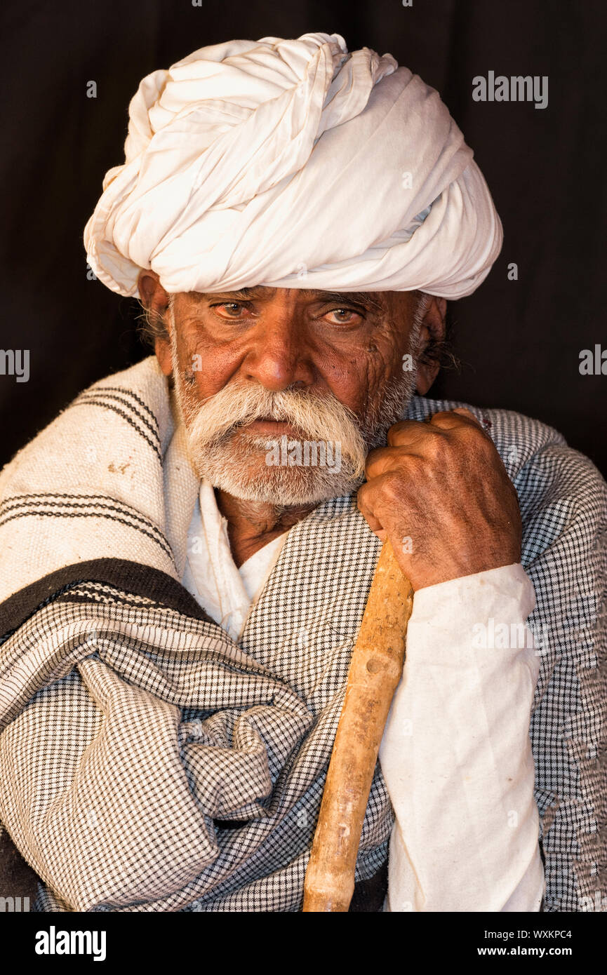 Rabari tribe man with walking stick, Great Rann of Kutch Desert, Gujarat, India Stock Photo