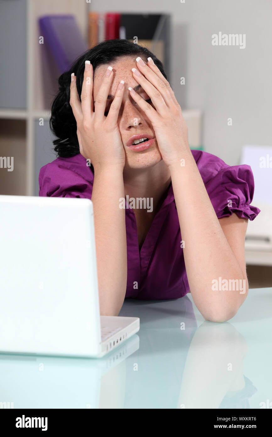 Woman covering her face with her hands Stock Photo - Alamy