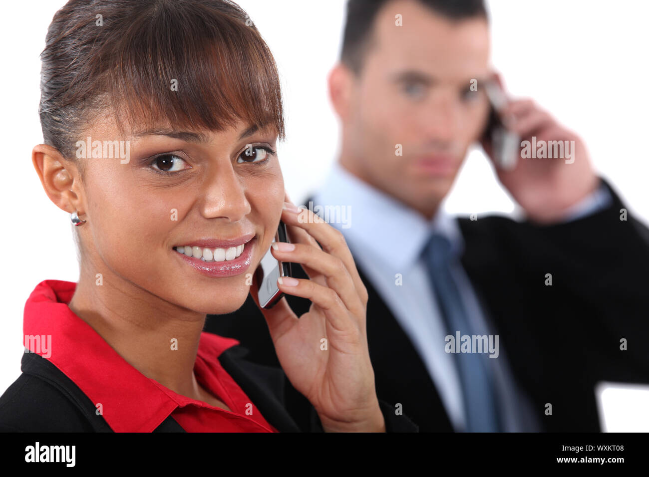 Businesspeople using cellphones Stock Photo