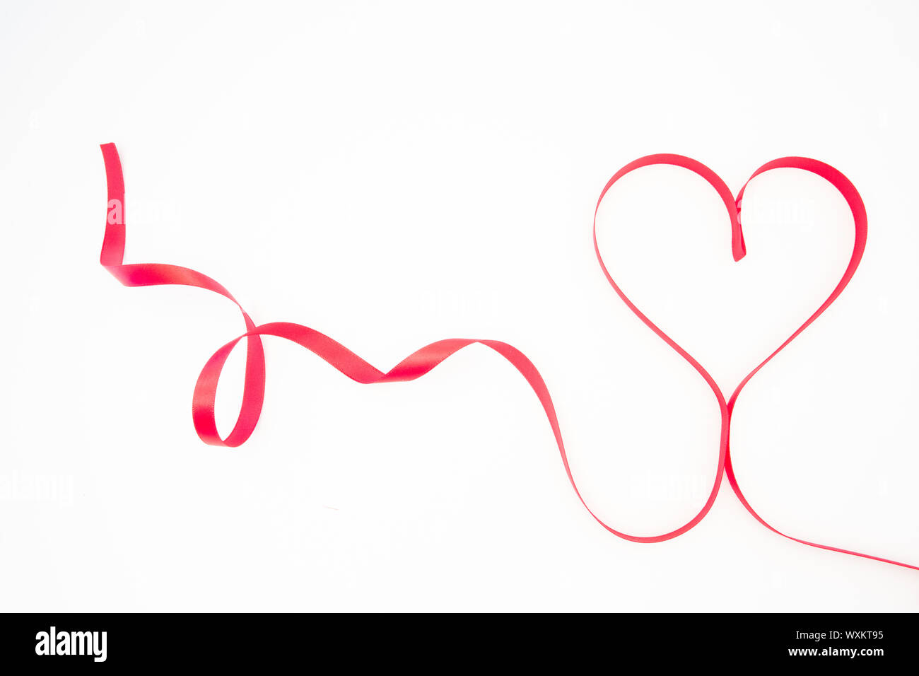 Decorative pink ribbon shaped into heart on white background Stock ...