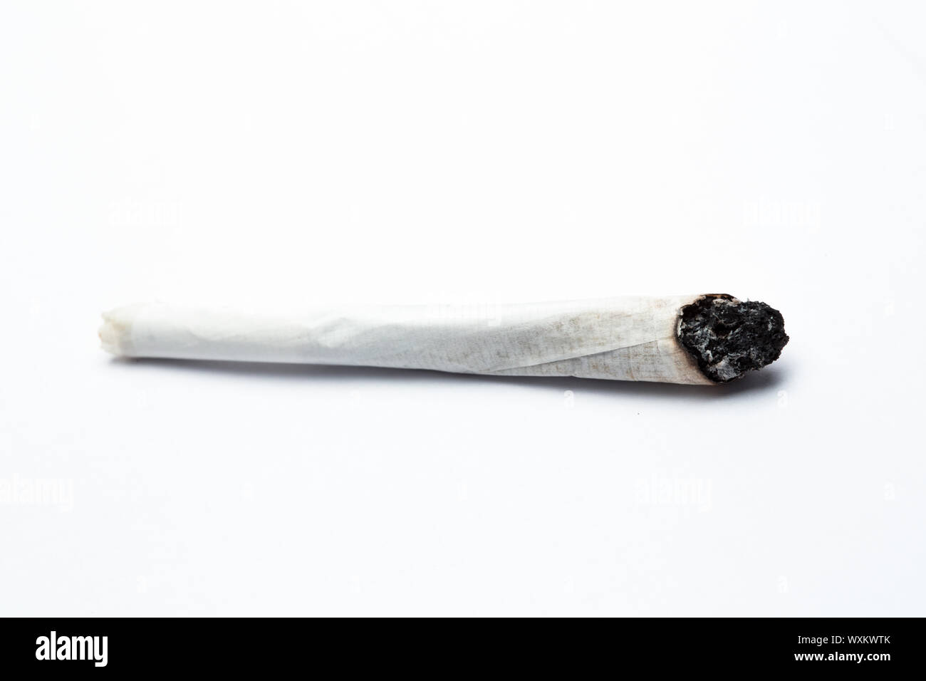 Burning joint of marijuana on white background Stock Photo Alamy
