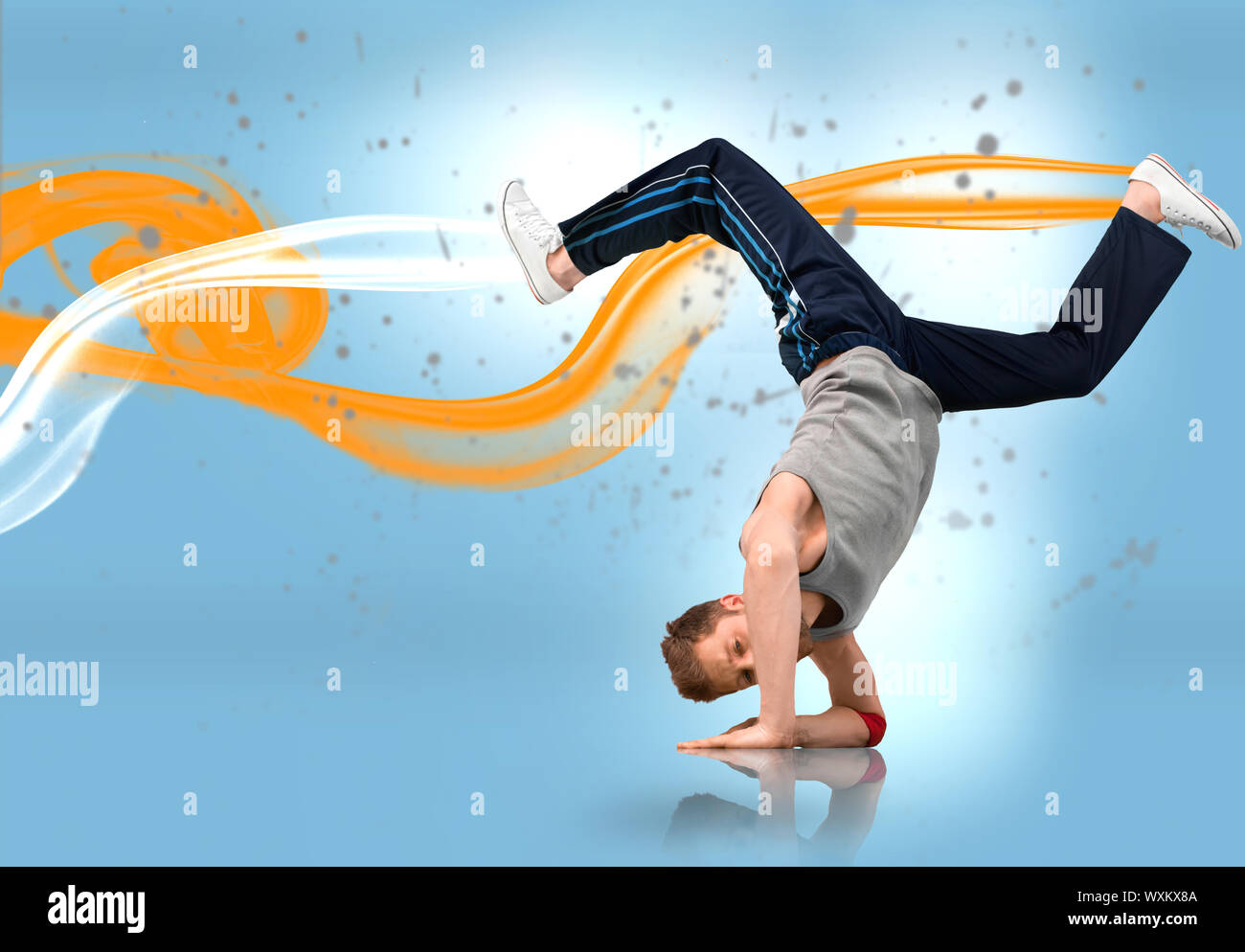 Break dancer busting out a move with yellow and white smoke trails on ...