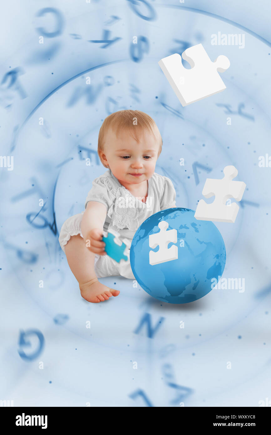Baby holding a blue jigsaw piece sitting next to a globe with floating letters on background Stock Photo
