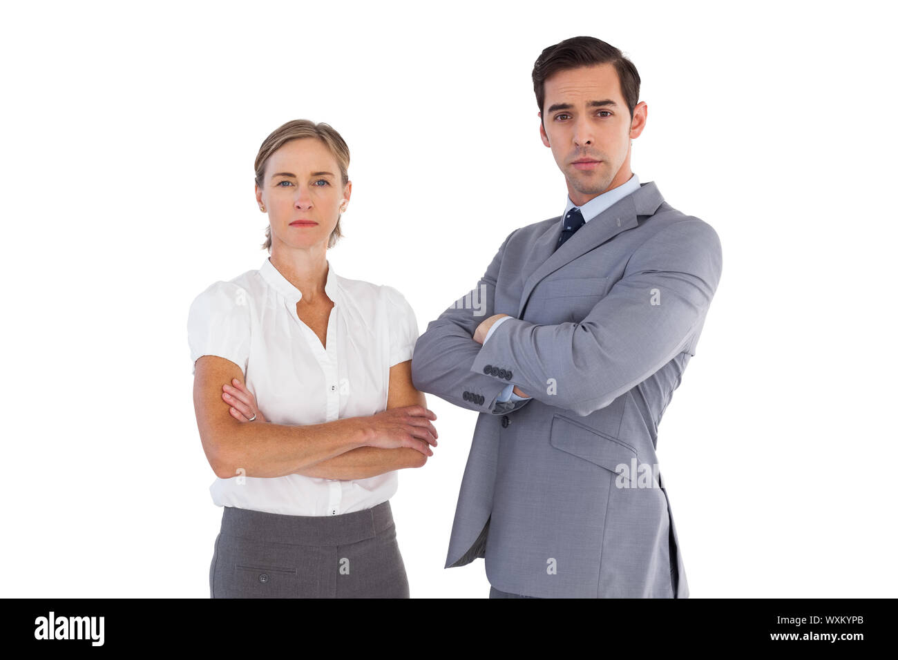 Serious co workers standing together smiling on white background Stock ...