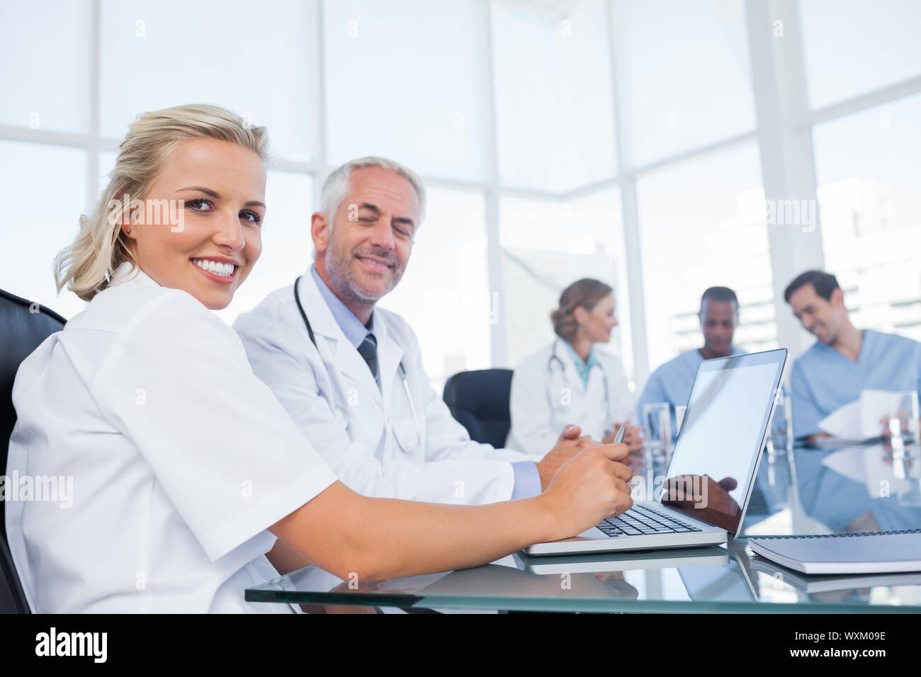 Two doctors smiling and looking at the camera Stock Photo
