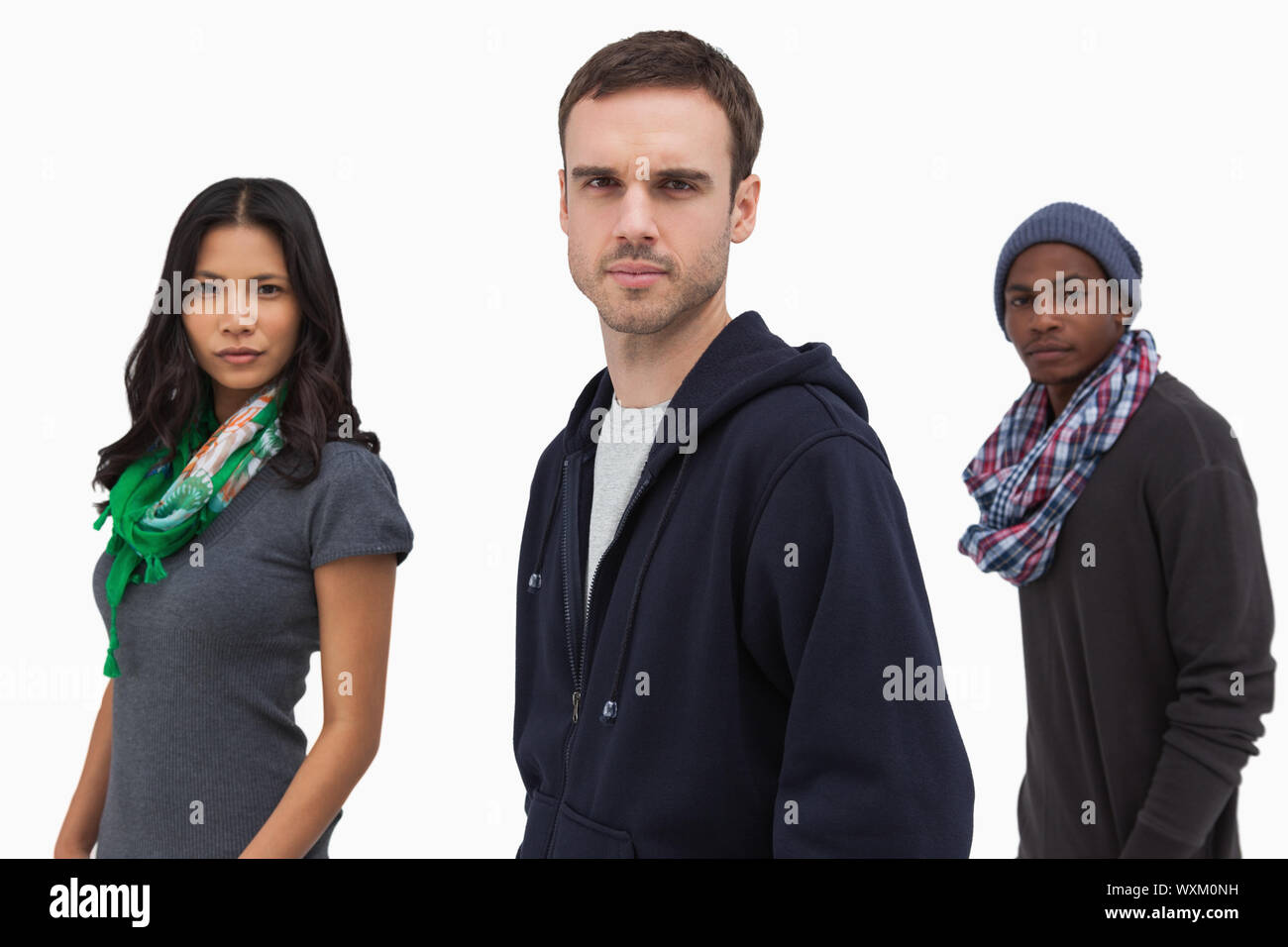 Serious stylish young people in a line on white background Stock Photo