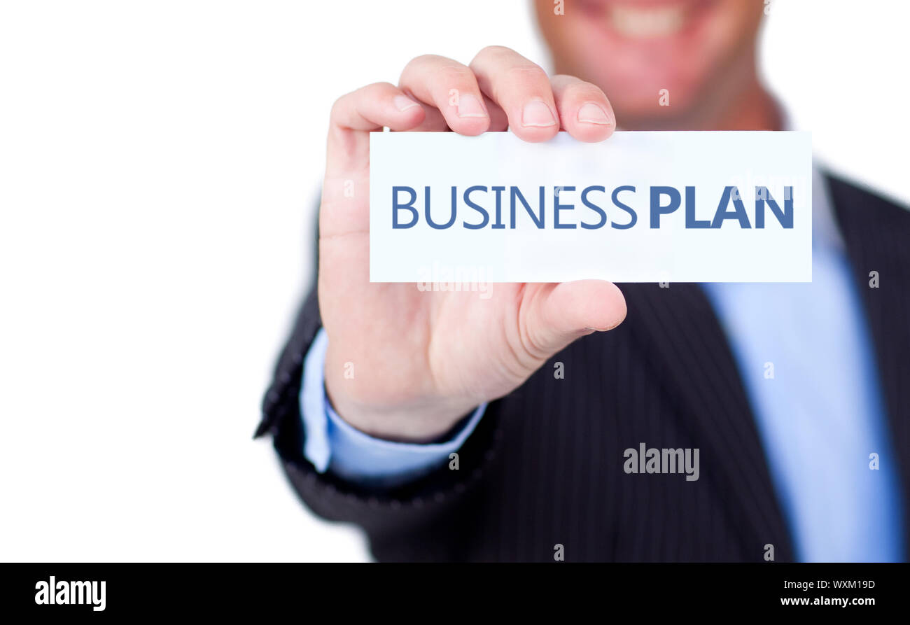 Businessman holding a label with business plan written on it on white ...