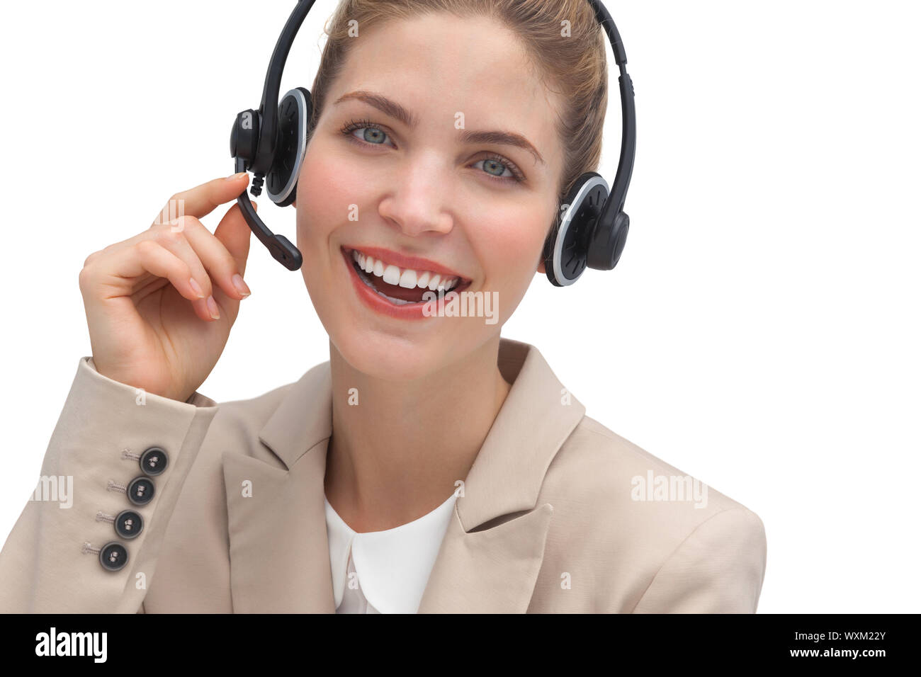 Laughing operator talking on headset looking at the camera Stock Photo