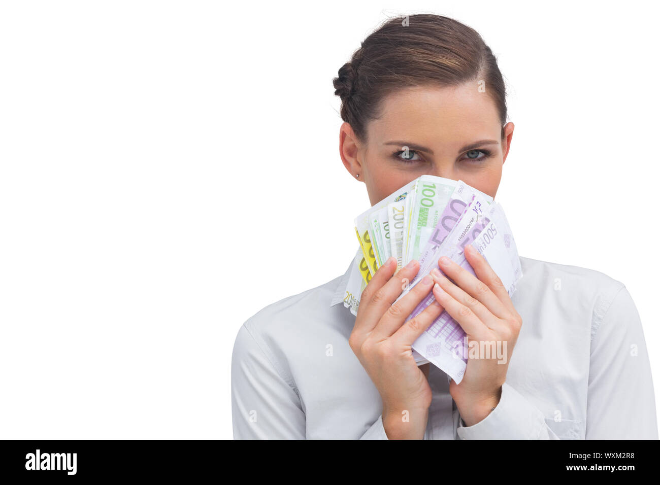 Businesswoman hiding behind money in her hand on white background Stock Photo