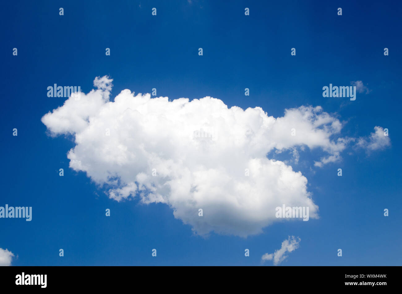 white fluffy clouds with rainbow in the blue sky Stock Photo