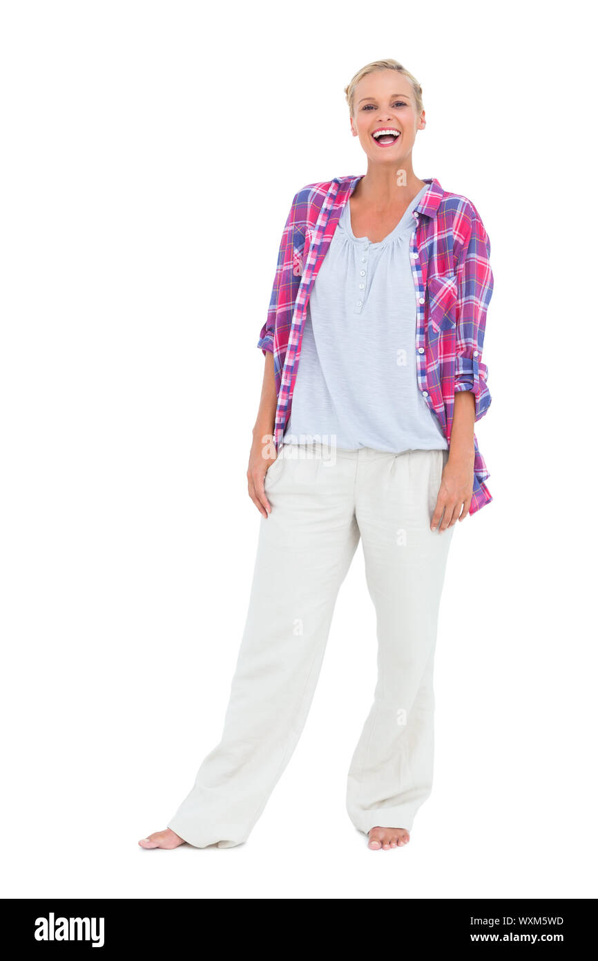 Pretty woman standing with her hands on her hips on white background ...