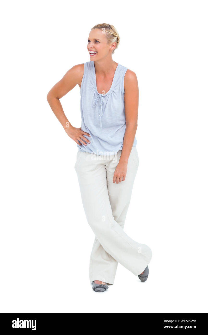 Pretty woman smiling with hands on hips and laughing on white ...