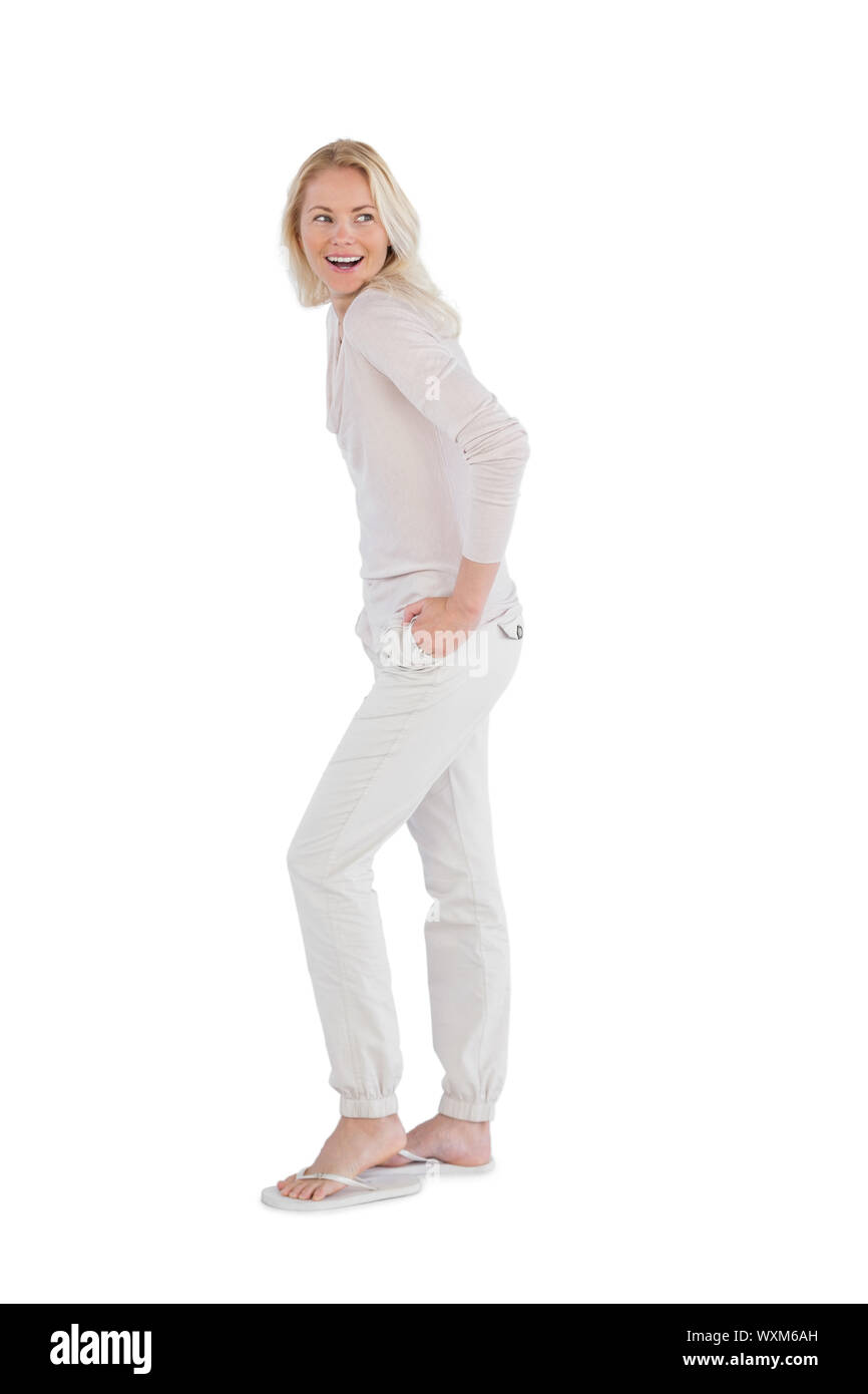 Happy woman with hands in pockets on a white background Stock Photo - Alamy
