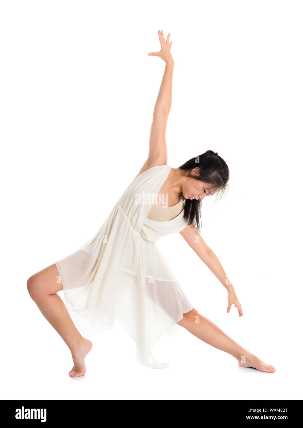Modern Asian teen contemporary dancer poses in front of the studio