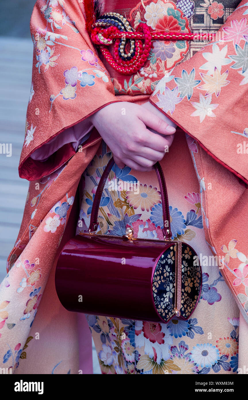 Details of a Japanese kimono and purse at a shinto wedding on