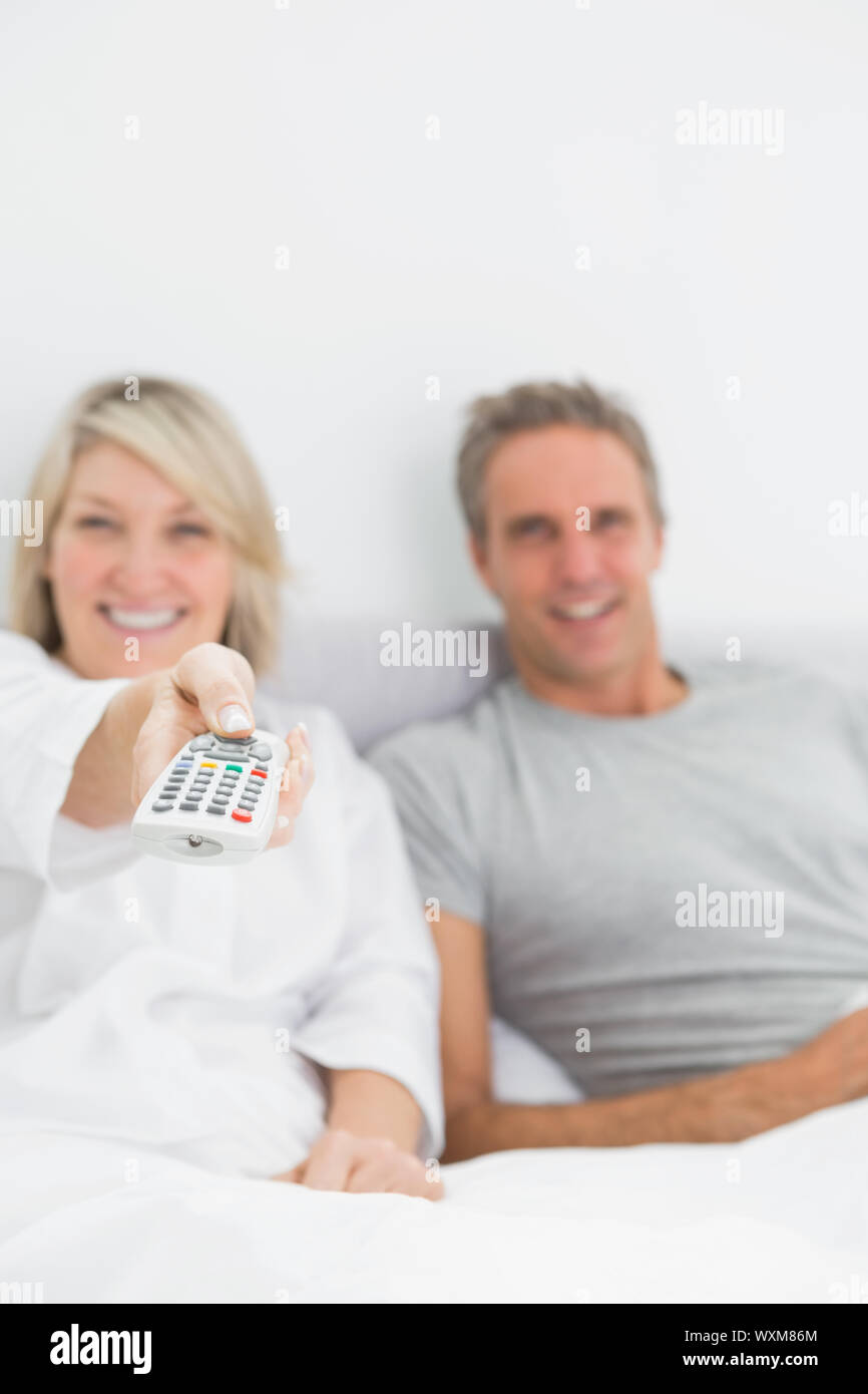 Relaxed couple watching tv in bed at home in bedroom Stock Photo Alamy