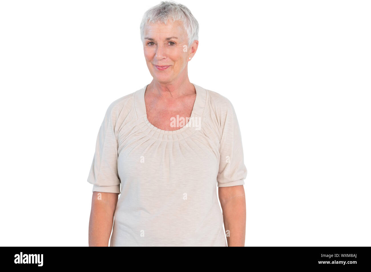 Mature woman smiling at camera on white background Stock Photo - Alamy