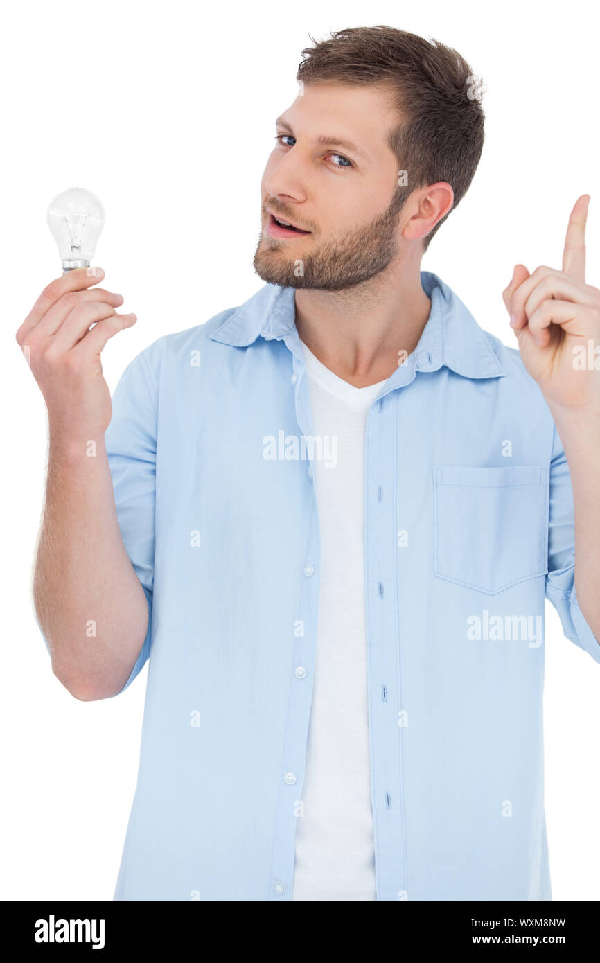 Sceptical Model On White Background Holding A Bulb And Getting