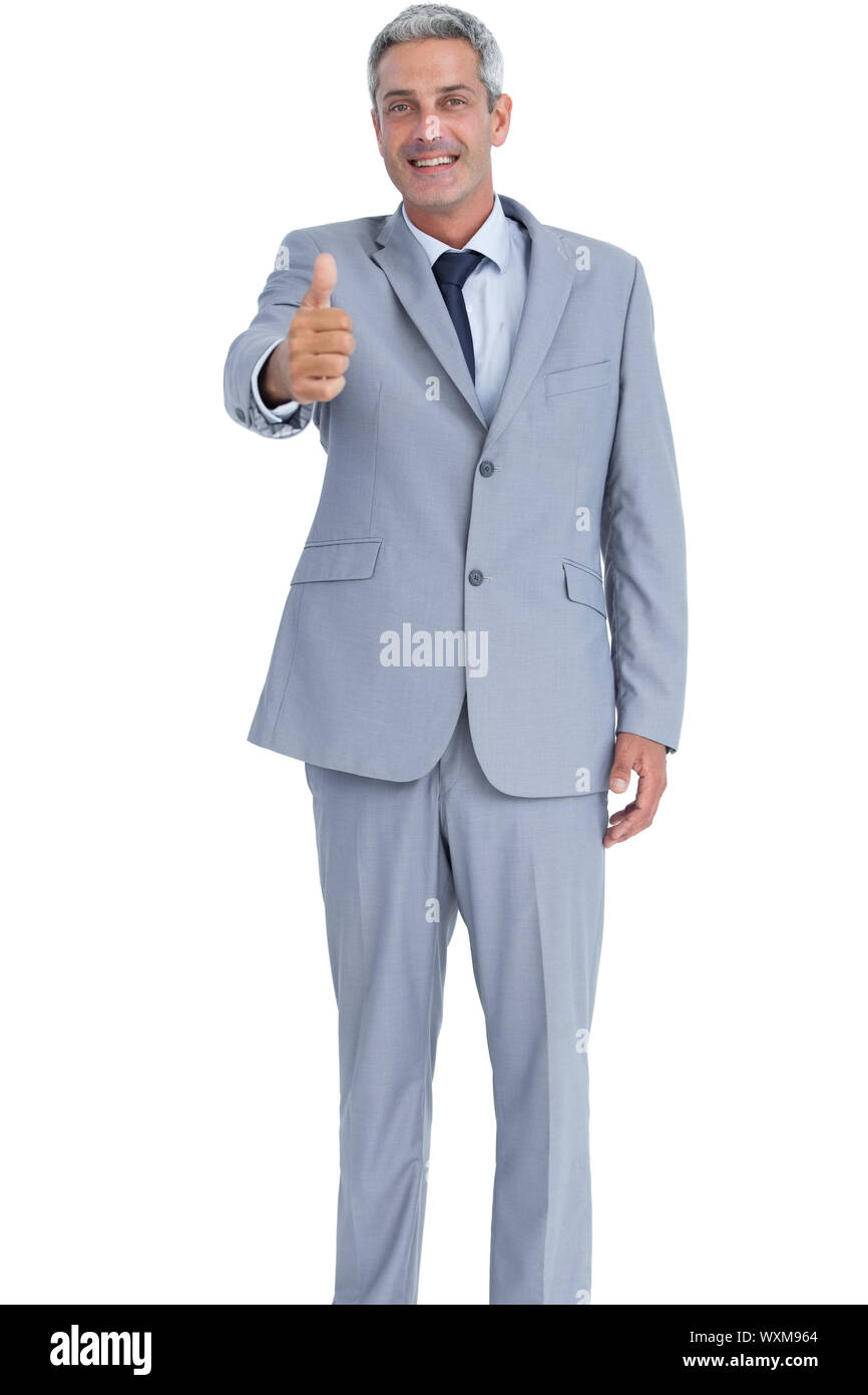 Positive businessman showing thumb up against white background Stock ...