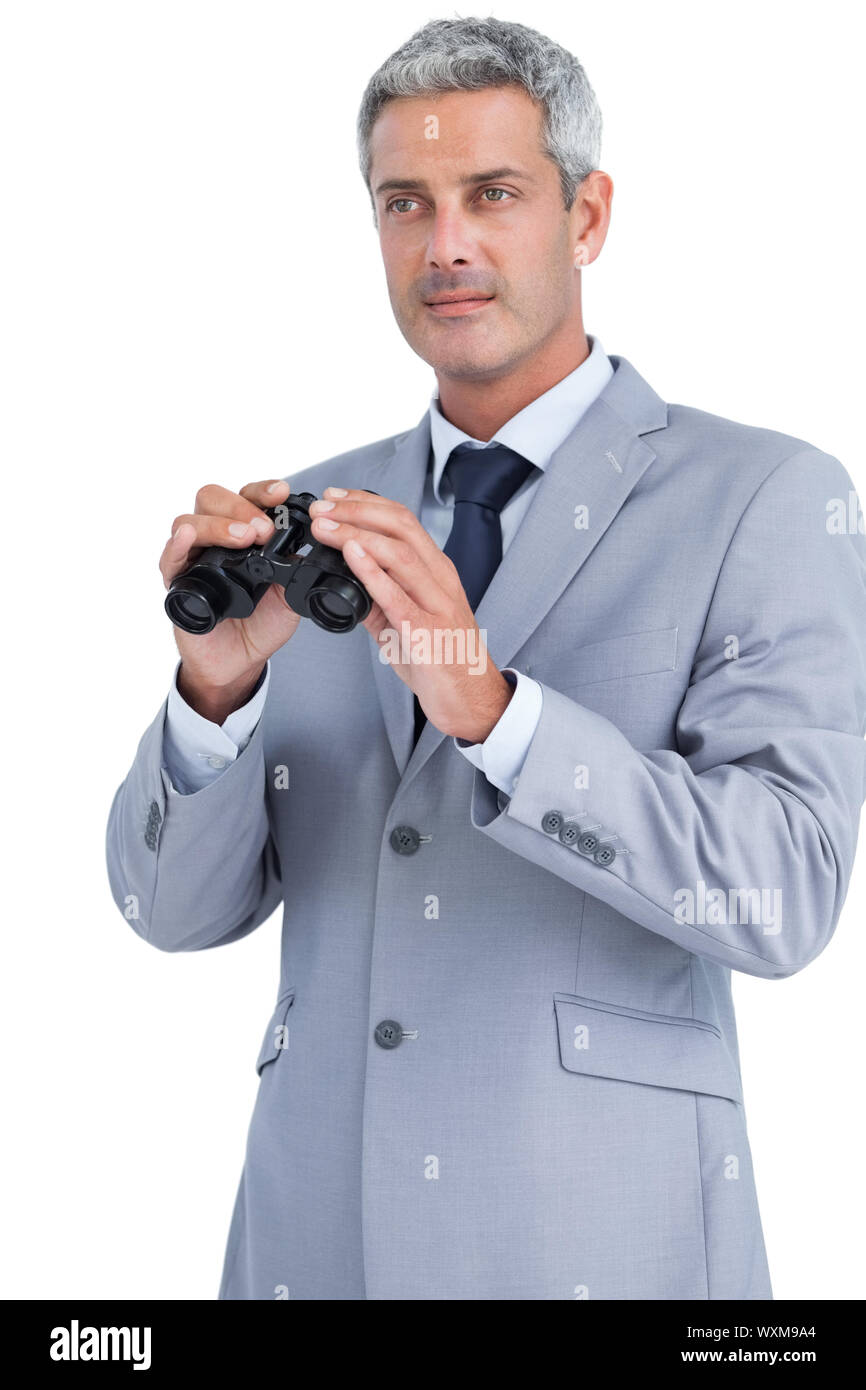 Businessman posing with binoculars on white background Stock Photo