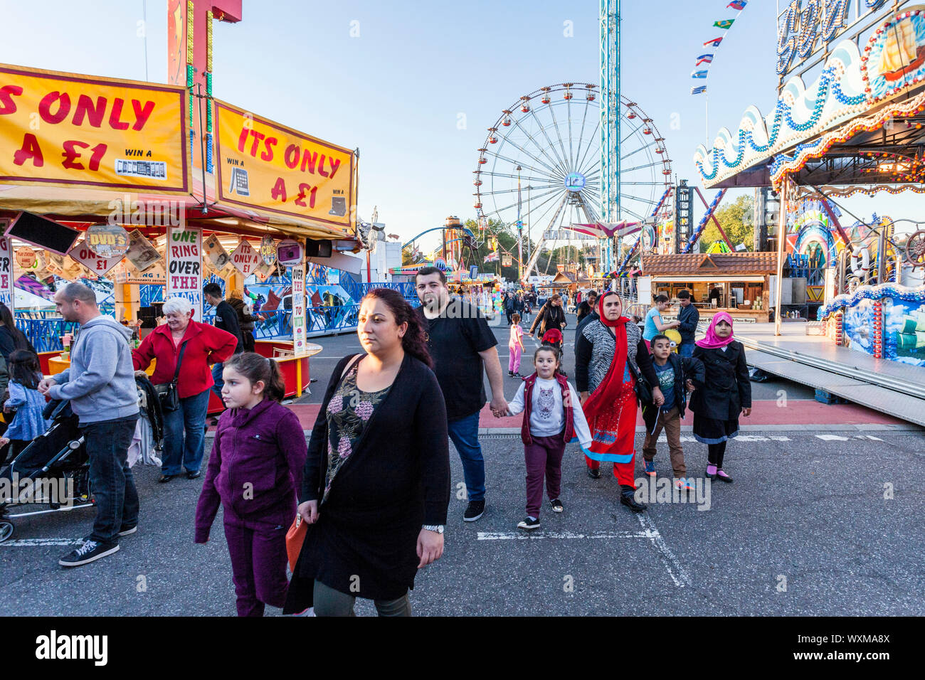 Families at a fairground. Adults and children at Goose Fair, Nottingham, England, UK Stock Photo