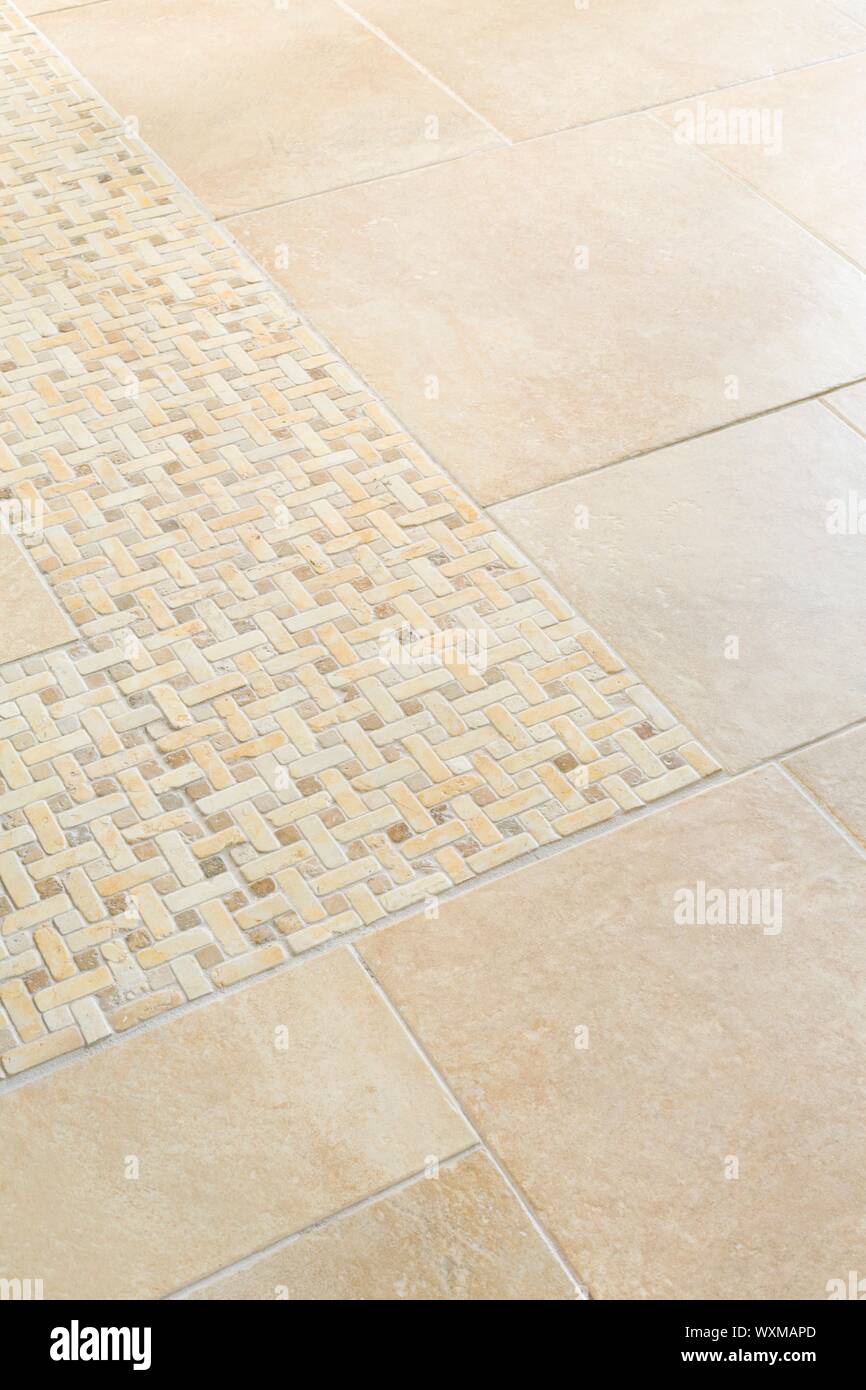 Porcelain floor tiles with a stone mosaic design in a neutral cream colour Stock Photo