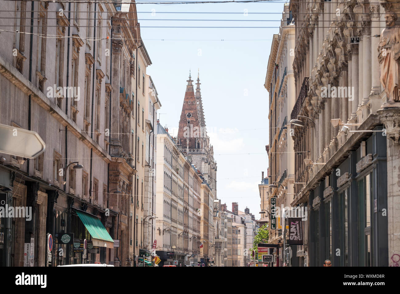 LYON, FRANCE - JULY 14, 2019: Eglise Saint Nizier Church on Rue Paul Chenavard Street in Lyon, France, with Haussmann style buildings and some commerc Stock Photo