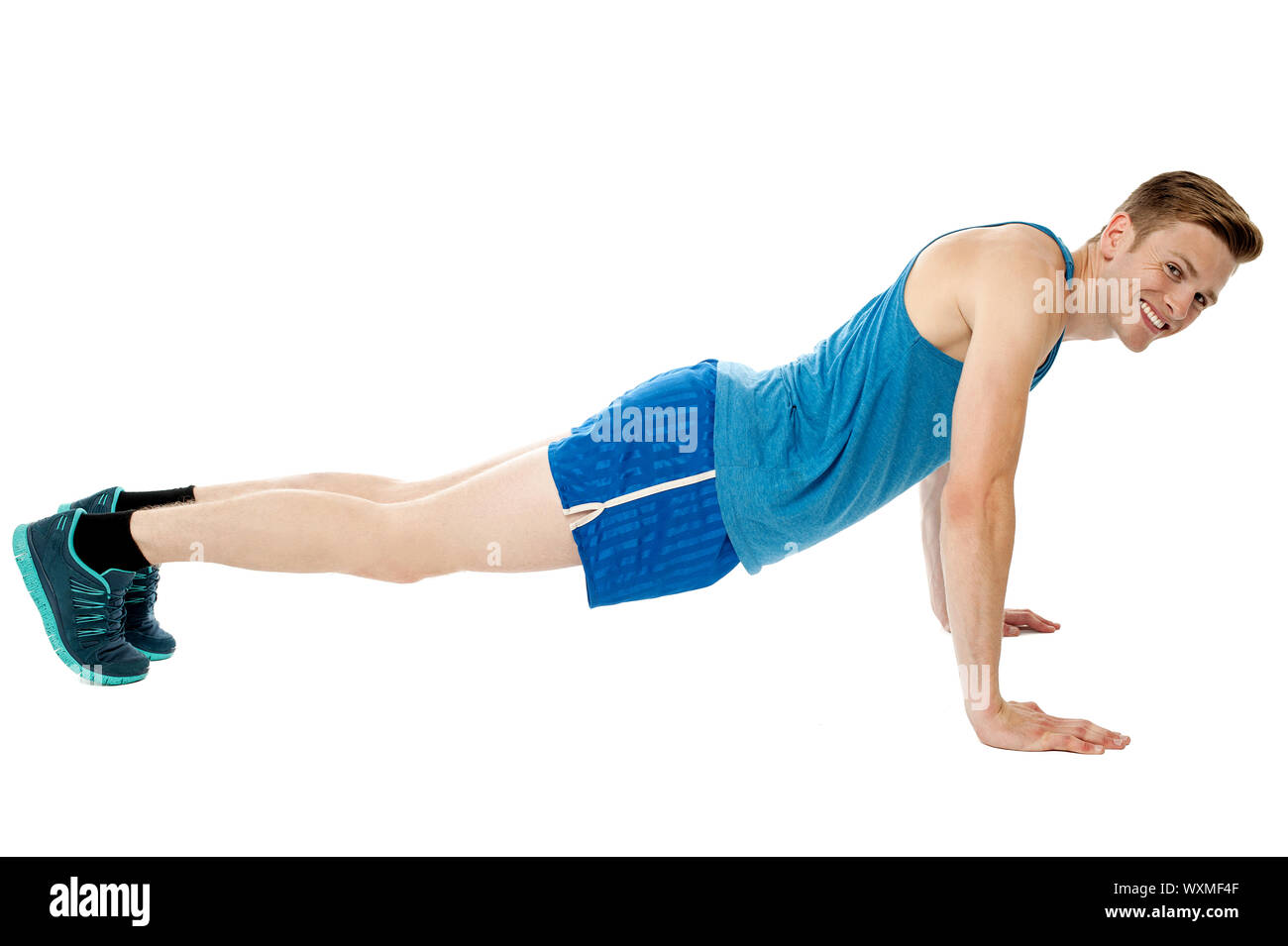 Young smiling fitness man doing push ups on floor Stock Photo - Alamy