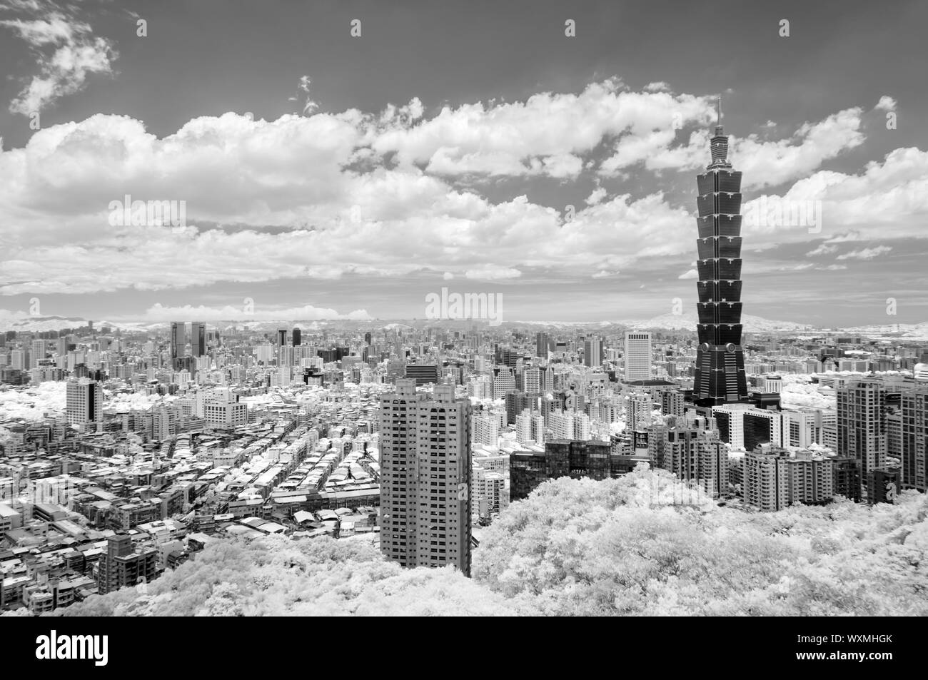 Taipei cityscape with dramatic clouds at sky, infrared photography in black and white. Stock Photo