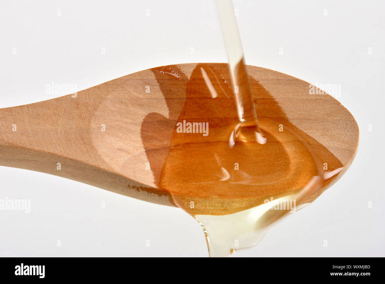 organic olive oil and a timber spoon Stock Photo - Alamy