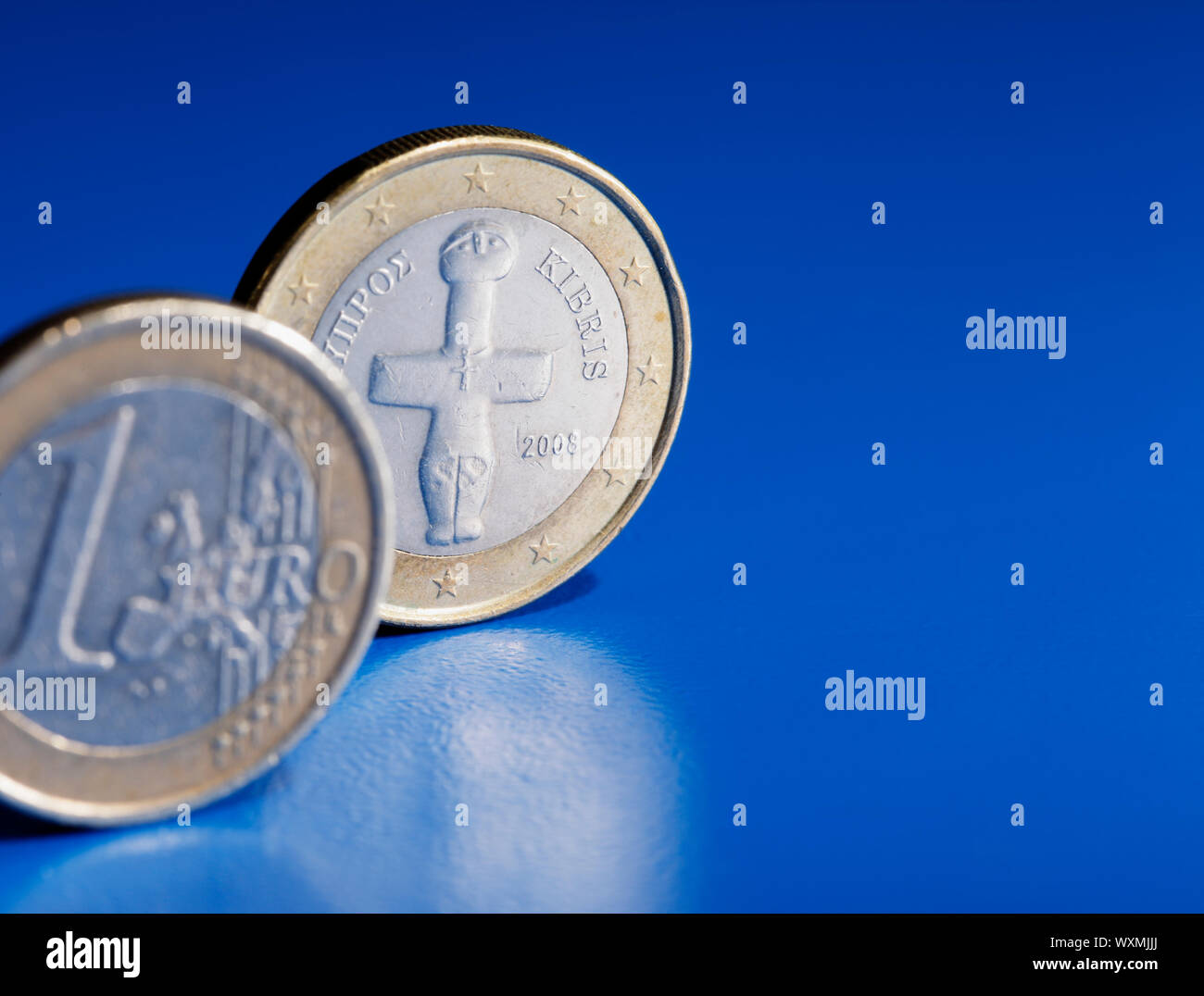 Euro coins from Cyprus on blue background. Stock Photo