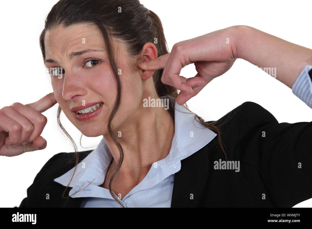 woman plugging her ears Stock Photo