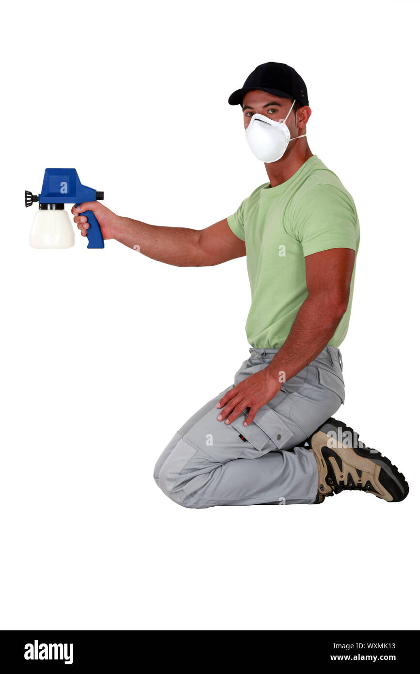 Man holding paint sprayer Stock Photo