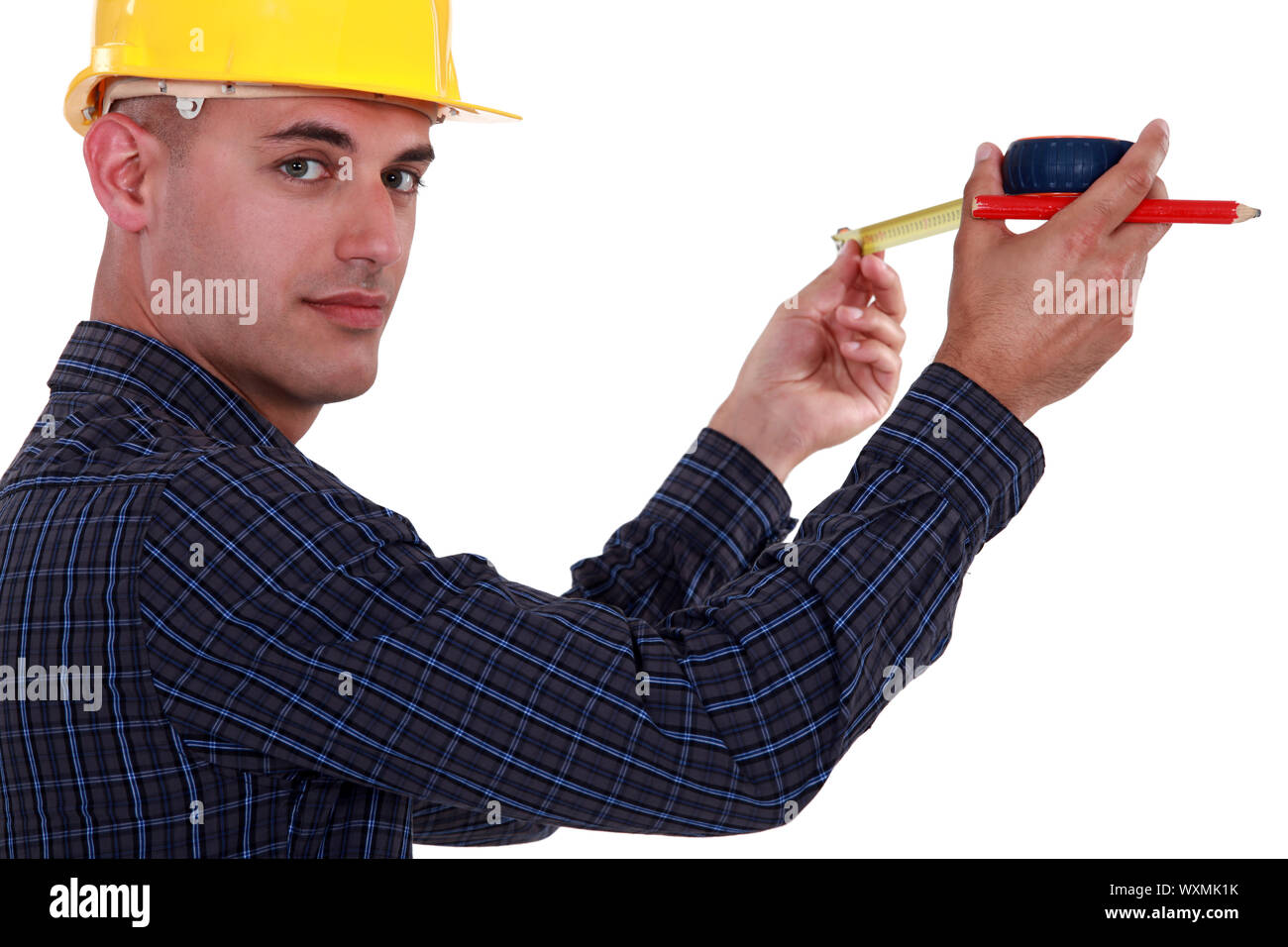 Tradesman using a measuring tape Stock Photo