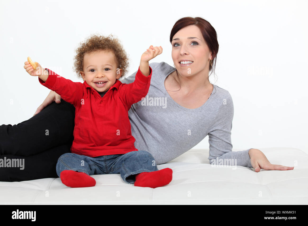 Toddler sat on the floor with mother Stock Photo - Alamy